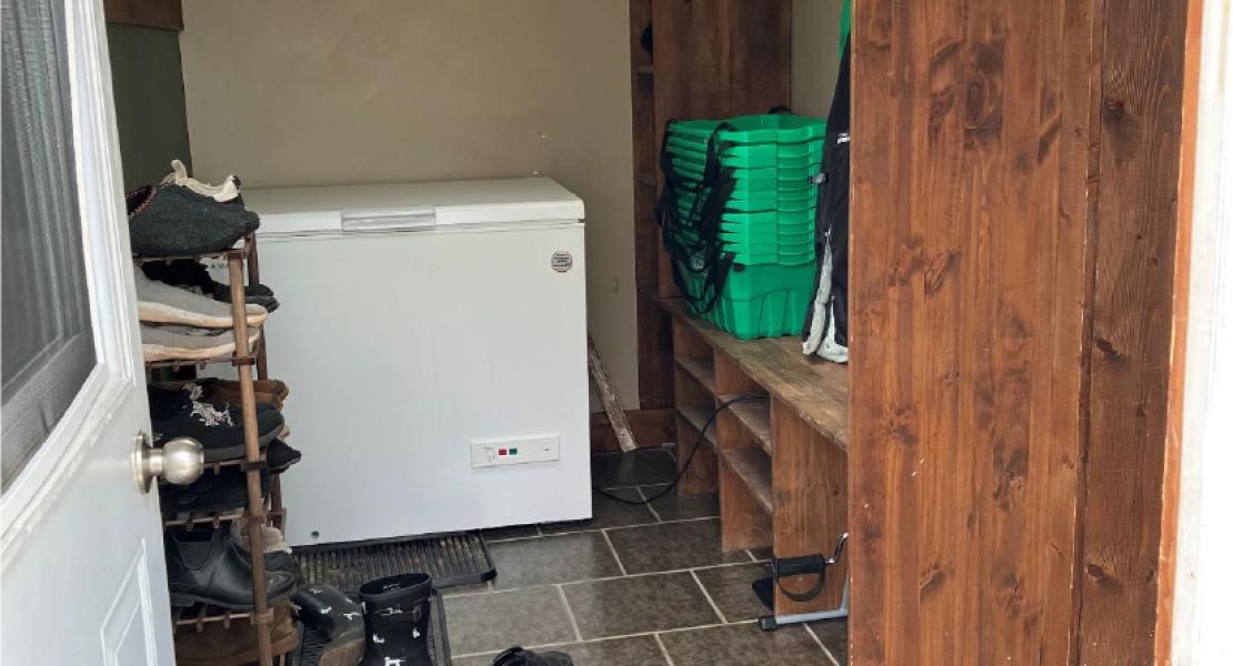 Entryway with tile floors, a shoe rack, storage shelf and deep freeze